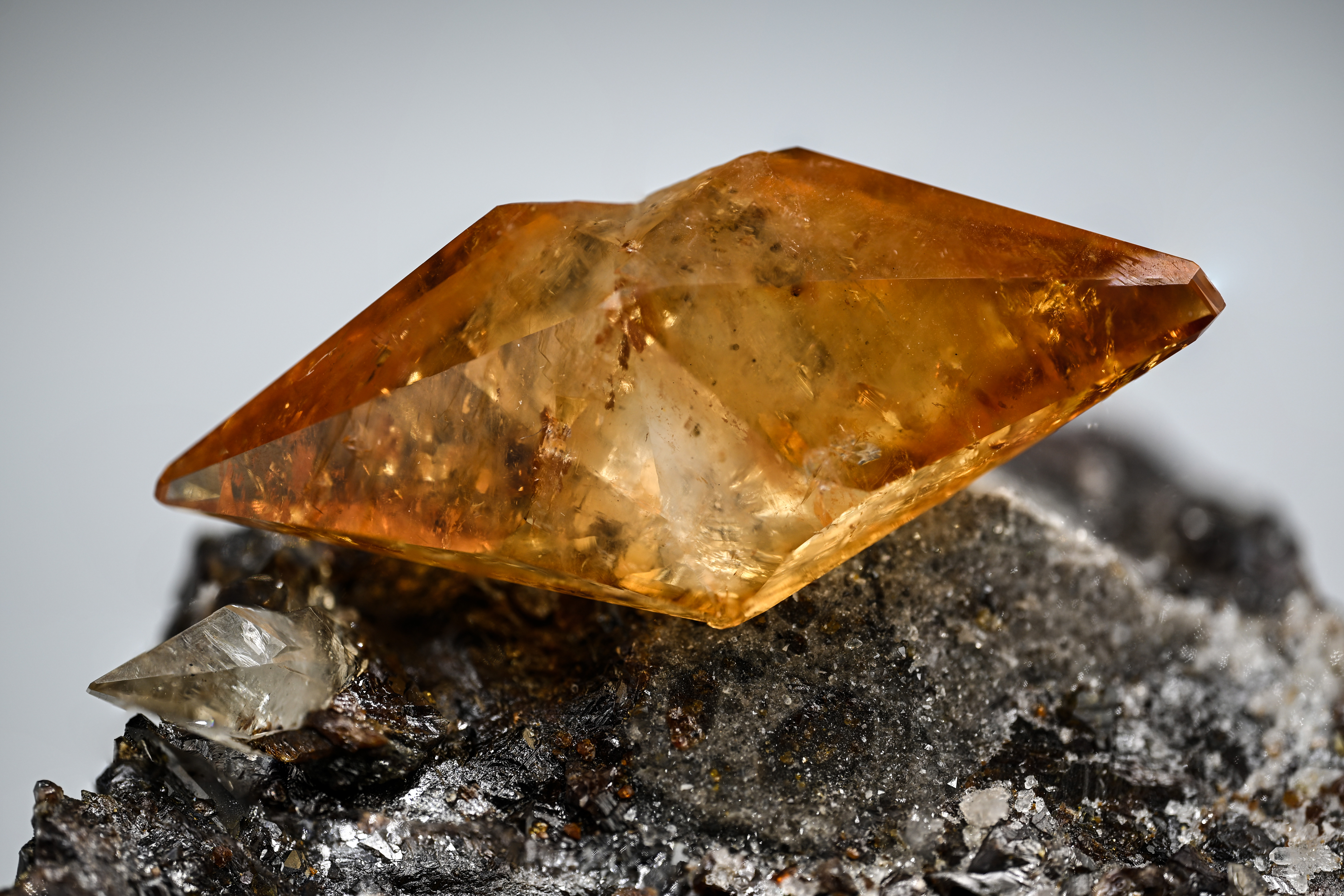 Calcite on Sphalerite – Gemmy Amber-Orange Scalenohedral Crystal on Lustrous Matrix