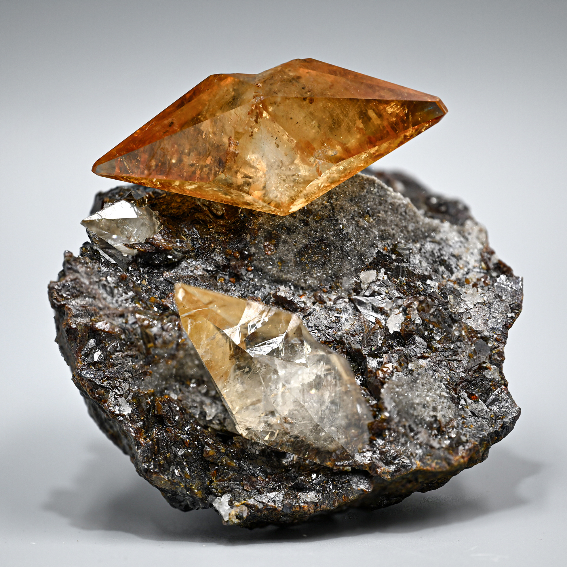 Calcite on Sphalerite – Gemmy Amber-Orange Scalenohedral Crystal on Lustrous Matrix